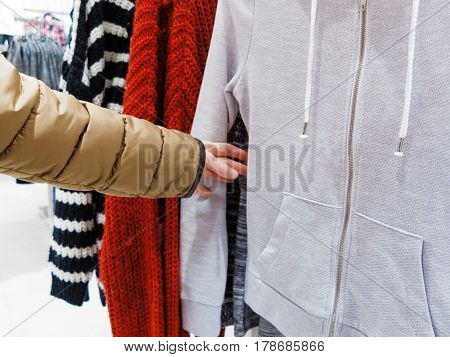 Shopping time concept. Part body buyer customer client wathing touching clothes in botique shop market.