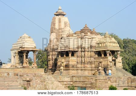 Khajuraho India - 30 January 2015: People climb to the hindu temple on UNESCO World Heritage Site Khajuraho Group of Monuments built between 950 and 1150