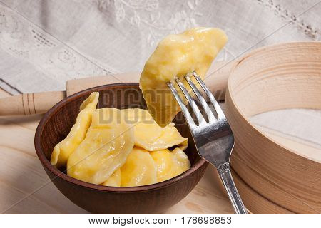 Close Up View Of Boiled Varenyky Or Dumpling With Cottage Cheese Or Curd On Metal Fork. Fresh Boiled