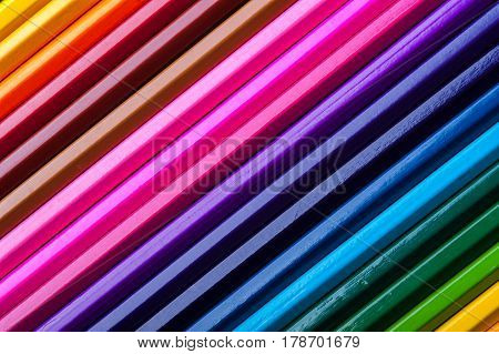 Macro view of colorful pencils. Assortment of multicolored wooden crayons. Drawing, sketching and school supplies.