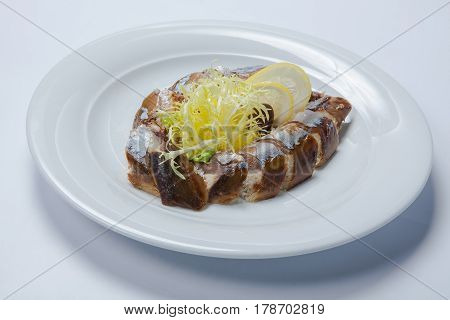 Slices Of Smoked Fish Mackerel Or Scomber On A White Rectangular Dish
