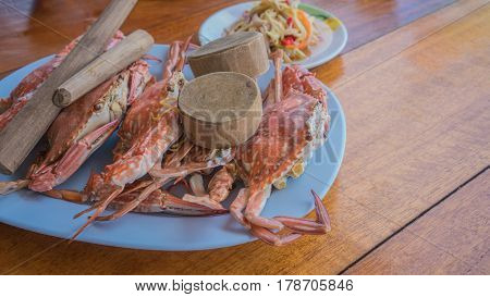 Fresh steamed crab with tools served in seafood restaurant at Mae Rumphueng Beach , Rayong , Thailand