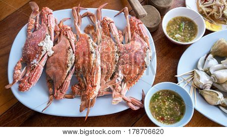 Fresh steamed crab with tools and spicy seafood sauce served in seafood restaurant at Mae Rumphueng Beach Rayong Thailand
