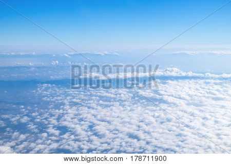 white wispy cirrus and cirrostratus clouds taken from airplane
