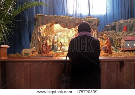 ZAGREB, CROATIA - DECEMBER 28: A woman prays in front of the Christmas creches in the Basilica of the Sacred Heart in Zagreb, on December 28, 2015.