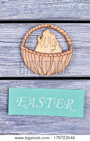Plywood bunnies in a basket. Easter festive card. Best wishes for spring holiday.