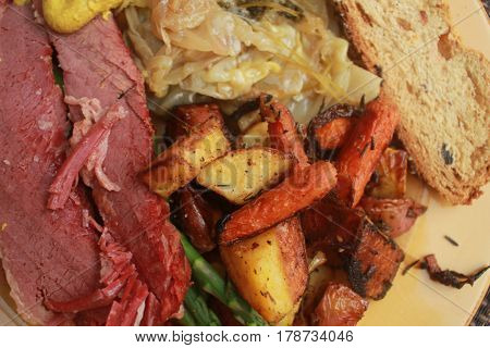 Saint Patrick's day dinner with corned beef,carrots,potatoes,cabbage and soda bread up close