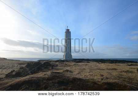 Iceland's coastal views of Malarrif Lighthouse on the horizon.
