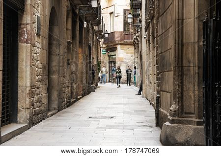 BARCELONA SPAIN - OCTOBER 22 2015: Narrow street in gothic quarter of Barcelona the capital city of the autonomous community of Catalonia in the Kingdom of Spain