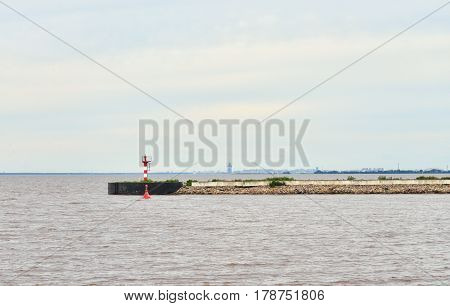 View of the pier and the Gulf of Finland in Strelna on the outskirts of St. Petersburg at cloud summer day.