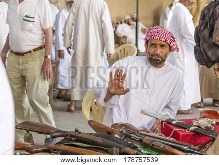 Nizwa Oma 24th March 2017: omani men selling guns at Nizwa market