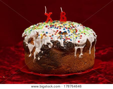 Easter cake with candle on dark background morning after easter