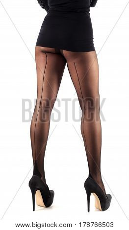 Sexy female legs in beautiful stylish stockings and high heels shoes black gloves and dress isolated on white background
