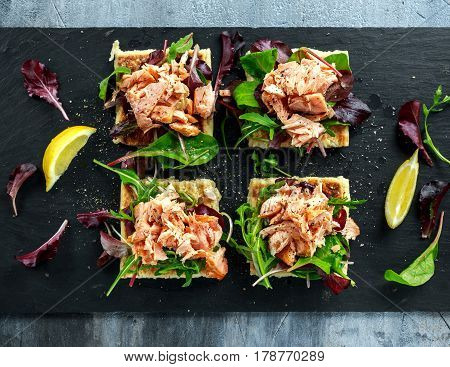 Smoked salmon flakes on salad bed and irish potato slims snacks, appetizers.