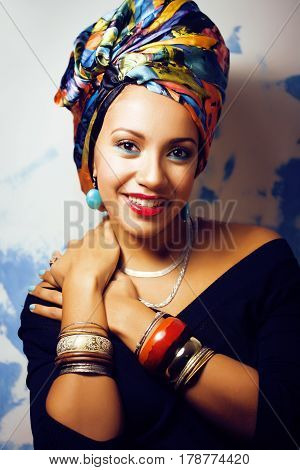 beauty bright real african woman with creative make up, shawl on head like cubian closeup smiling
