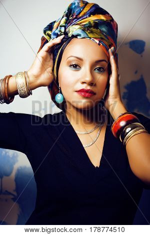 beauty bright real african woman with creative make up, shawl on head like cubian closeup smiling