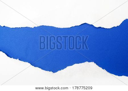 torn white paper on blue background. Cocept for autism awareness day.