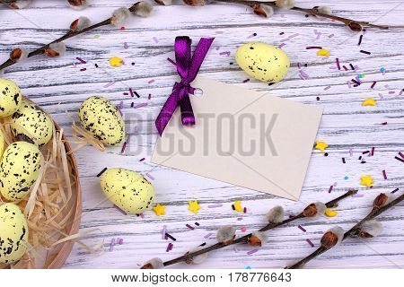 Easter Background With Yellow Easter Eggs Pussy Willow Branches Purple Ribbon And Space For Text.