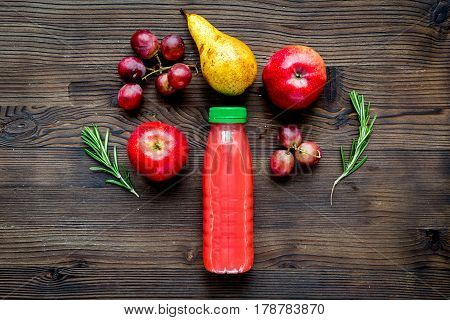 fresh multifruit drink in plastic bottle on wooden table background top view mock-up