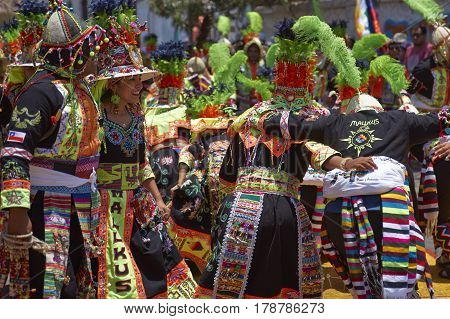 ARICA, CHILE - FEBRUARY 11, 2017: Tinkus Dance Group dressed in ornate costumes performing a Tinkus dance during a street parade at the annual Carnaval Andino con la Fuerza del Sol.