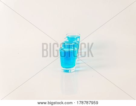 Four Glasses Of Blue Kamikaze, Glamorous Drink, Mixed Drink Poured Into Shot Glasses