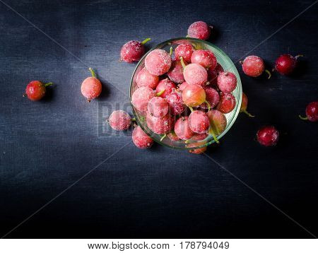 Frozen And Fresh Berries In A Glass Pial On A Black Background.