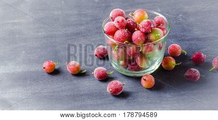 Frozen And Fresh Berries In A Glass Pial On A Black Background.