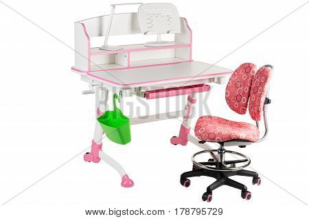 Pink chair pink school table green basket and desk lamp on the white isolated background.