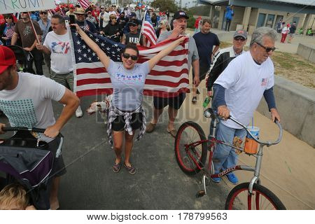 Huntington Beach, CA - March 25 2017: Make America Great Again March. Thousands of Supporters of republican president Donald Trump, wave flags, signs and march at a MAGA March in Huntington Beach. 

