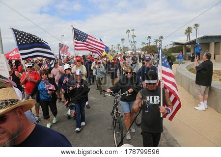 Huntington Beach, CA - March 25 2017: Make America Great Again March. Thousands of Supporters of republican president Donald Trump, wave flags, signs and march at a MAGA March in Huntington Beach. 

