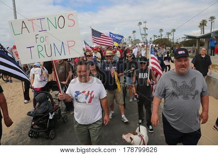 Huntington Beach, CA - March 25 2017: Make America Great Again March. Thousands of Supporters of republican president Donald Trump, wave flags, signs and march at a MAGA March in Huntington Beach. 

