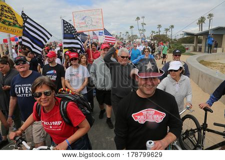 Huntington Beach, CA - March 25 2017: Make America Great Again March. Thousands of Supporters of republican president Donald Trump, wave flags, signs and march at a MAGA March in Huntington Beach. 


