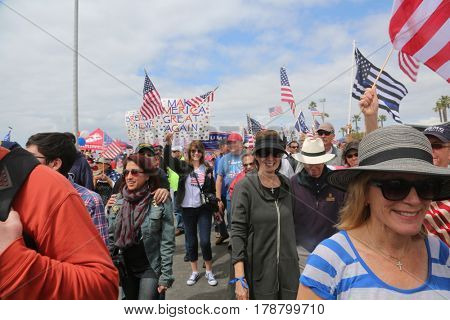 Huntington Beach, CA - March 25 2017: Make America Great Again March. Thousands of Supporters of republican president Donald Trump, wave flags, signs and march at a MAGA March in Huntington Beach. 
