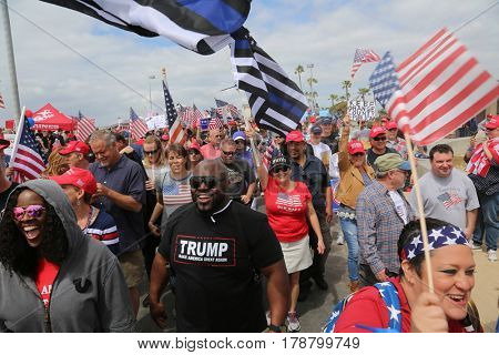 Huntington Beach, CA - March 25 2017: Make America Great Again March. Thousands of Supporters of republican president Donald Trump, wave flags, signs and march at a MAGA March in Huntington Beach. 
