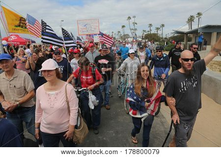 Huntington Beach, CA - March 25 2017: Make America Great Again March. Thousands of Supporters of republican president Donald Trump, wave flags, signs and march at a MAGA March in Huntington Beach. 
