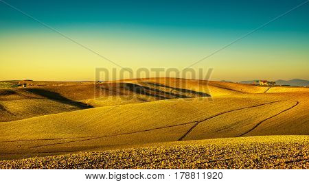 Tuscany countryside panorama rolling hills and plowed fields on sunset. Pisa Italy Europe