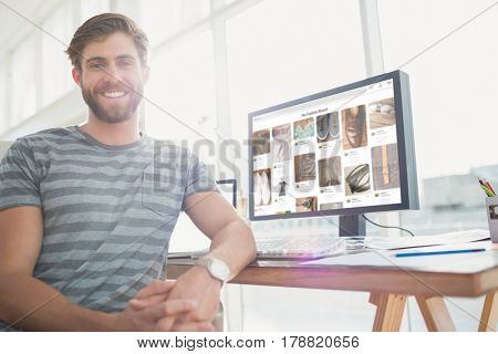 Portrait of a casual businessman posing and smiling against composite image of website page Portrait of a casual businessman posing and smiling in the office