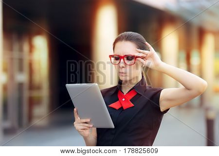 Discontent Businesswoman with Pc Tablet and Red Glasses