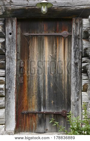 Old wooden rusty cabin door with antique locke. Norway