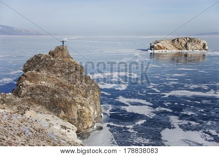 Man On Top Of Island's Oltrek Cape Lake Baikal. Adventure