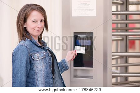 Young Woman Puts The Card Into The Reader System