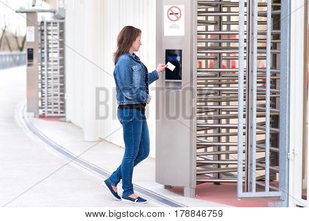 Young Woman Puts The Card Into The Reader System