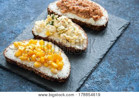Mix Of Rye Bread Bruschettas With Various Filling. Sweet Corn Omlet Tuna Seeds Cheese Avocado Sandwi