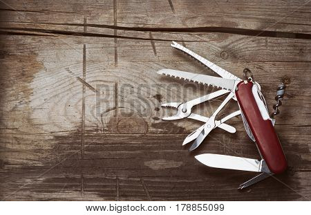 Old Swiss Knife On A Wooden Background