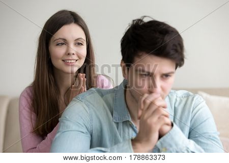Guilty lady making apology, asking sad serious man to forgive her. Woman begging pardon, expressing regret for mistake. Girl asking guy for forgiveness. Excuses, saying I m sorry, please, I was wrong