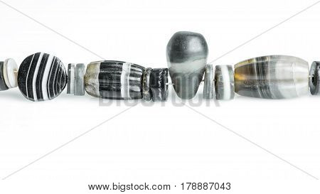Variety of ancient banded agate beads isolated on white background