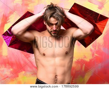 Caucasian Bearded Sexy Macho Man Holding Red Packages Or Bags