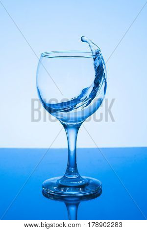 a glass of water on white background.a glass of freezing water