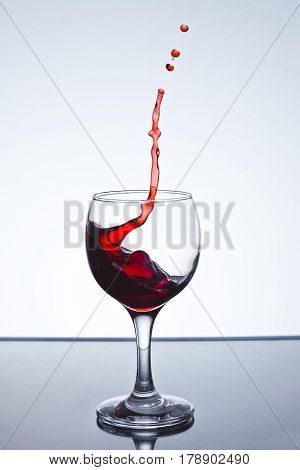Red wine splash over white background on a white background freezing
