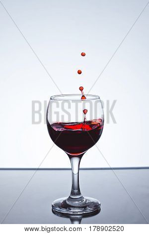 Red wine splash over white background on a white background freezing